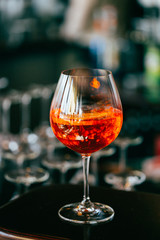 Glass of Orange Sangria Cocktail in the Bar with Amazing Blurred Background