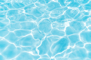 Fototapeta na wymiar Blue and bright water surface with sunrefection in swimming pool for background