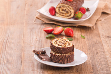 Chocolate roll with strawberries. 