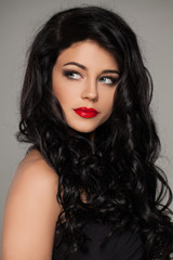 Elegant Woman. Perfect Makeup. Long Dark Curly Hair