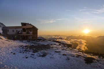 Tete Rousse refuge at sunset in the French Alps