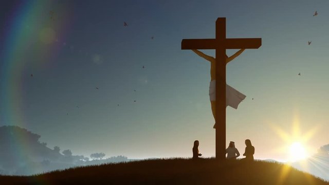 Christians praying at Jesus cross at sunset