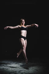 Obraz premium Girl dansing with flour on black background