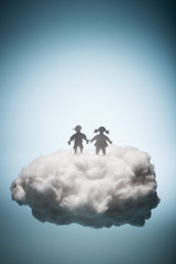 Two children standing on a white cloud.