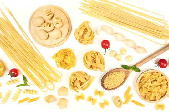 Overhead photo of different types of pasta on white