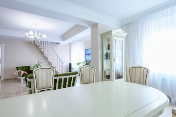Dining room interior white colors. Wide angle spacious contemporary interior room designs