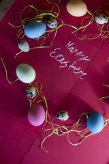A composition of colorful eggs on a red paper background