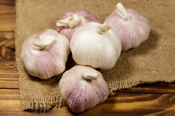 Bulbs of garlic on wooden table