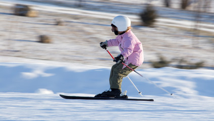 Girl skiing in a ski resort in winter