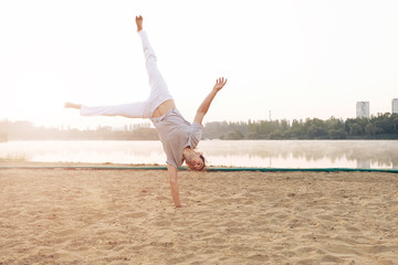 Casual athletic man on the beach while workout