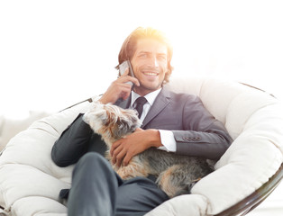 business man talking on the phone and holding his pet