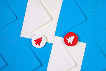 Pattern from blue and white envelopes with red and white wooden trees.