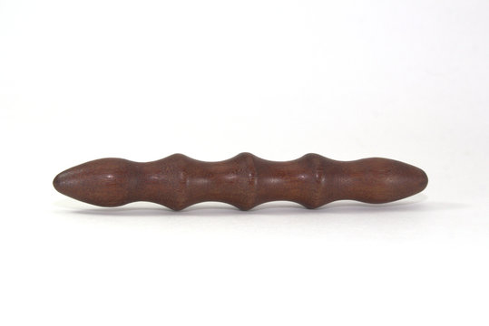 Japanese wooden brass knuckle of Javara wood of ant tree on white background close-up