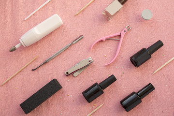Tools for manicure on pink background. Gel nail procedure equipment concept.