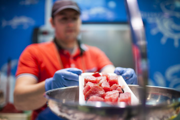 fishmonger weighing fish in the fish store