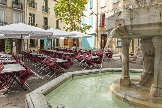  Fountain and terrace bar in square, place des neufs-jets in Ceret, France.