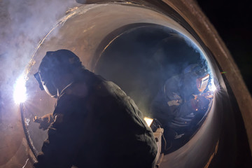 welder weld root weld from inside of big pipe