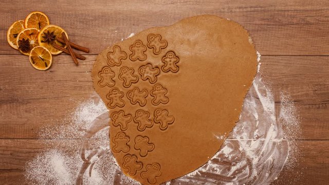Top view of making gingerbread cookies for the holiday season - stop motion animation of the process from stretching the dough to the baked cookies