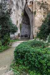 Fototapeta na wymiar So called Ear of Dionysius cave in ancient quarry, Neapolis Archaeological Park in Syracuse, Sicily Island of Italy