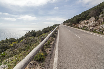 Road and sea view in Capo Caccia, Sardinia, Italy.