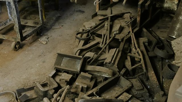 Pile of scrap metal on the floor in the blacksmith shop.