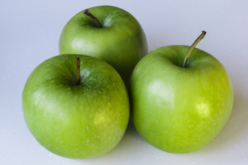 Closeup of Green Apples on White Background.