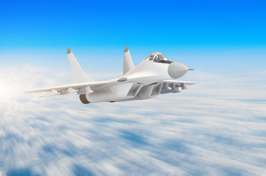 Military fighter aircraft at high speed, flying high in the sky.
