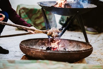 Rollo Brot Baking twist bread called in German Stockbrot or Schlangenbrot over an open fireplace. Favourite barbecue cooking outside in Switzerland at any season.  © nruedisueli