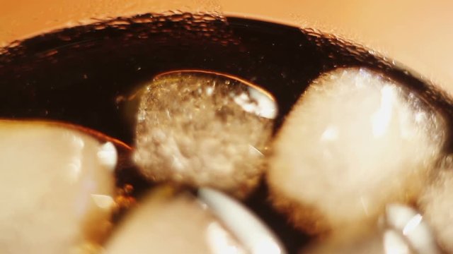 ce cubes in a dark liquid rotate