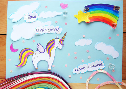 applique with a picture of a unicorn and a rainbow on a wooden background.I love unicorns