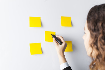 Woman writing on whiteboard