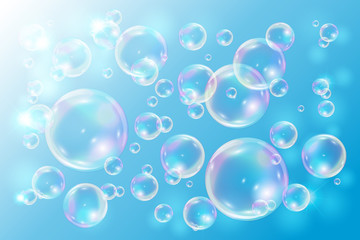 Bubbles soap on blue background. Bubbles with rainbow reflection.