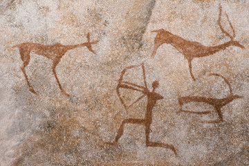 An image of an ancient man's hunting on the wall of a cave. ancient world history.