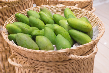 Fresh green raw manggoes display for sale at market