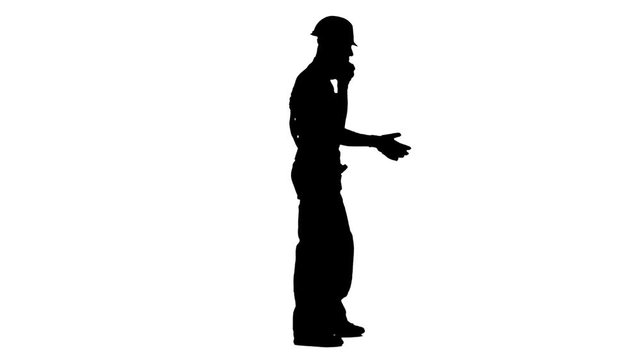 Foreman in a helmet and gloves speaks on the phone. White background. Silhouette. Side view