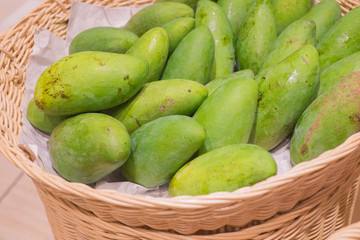 Fresh green raw manggoes display for sale at market