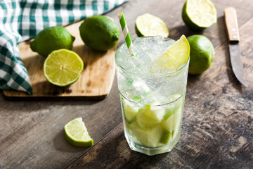 Caipirinha cocktail in glass on wooden table background.