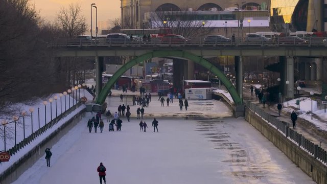 Tilt down of People Ice Skating on The Rideau Canal in Winter