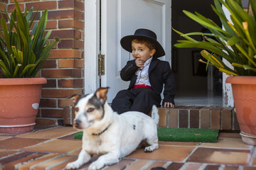Portrait baby boy with typical spanish regional costume and Jack Russell Terrier puppy. Jerez. Cadiz. Spain