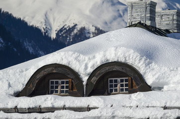 Fototapeta premium Small attic windows. Alps background
