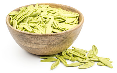 Olive leaves spinach pasta in a wood bowl isolated on white background raw.