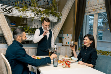 Couple enjoying a romantic meal together. sommelier presents and digests wine