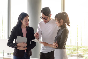 young asian business people, man and woman, working with team meeting in office
