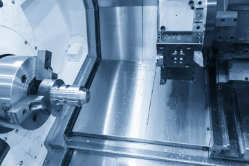 The  CNC lathe machine in the light blue scene.The  modern machining process.