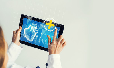 Close of female doctor hands working with tablet pc computer