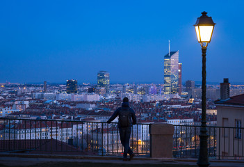 Man looking over the 6e arrondissement  from a park in Croix Rousse. Lyon, France.