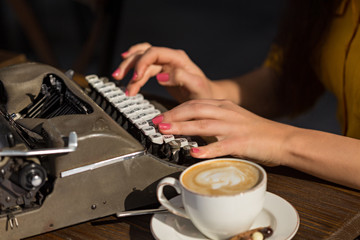 Fototapeta na wymiar Female hands typing on retro typewriter