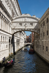Fototapeta premium Venice, Bridge of sighs with gondola. Characteristic little bridge that connect historical Ducal Palace with prison 