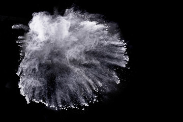 White powder explosion on black background.