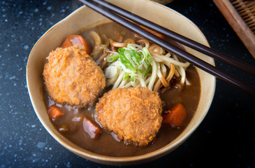 Japanese curry with udon noodle and croquettes topping.